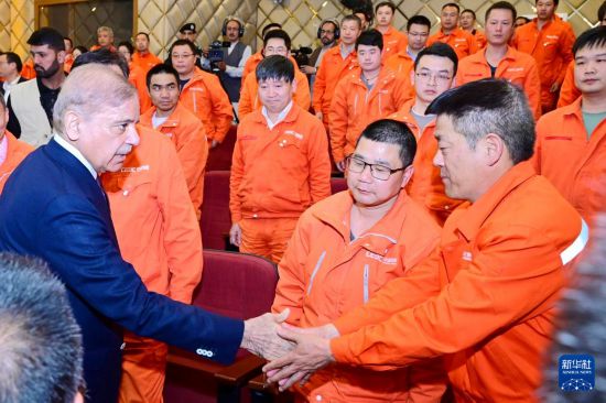 4月1日，在巴基斯坦西北部開伯爾-普什圖省達(dá)蘇，巴基斯坦總理夏巴茲（左）同達(dá)蘇水電站項目中方員工握手。新華社發(fā)（巴基斯坦新聞與廣播部下轄媒體信息部門供圖）