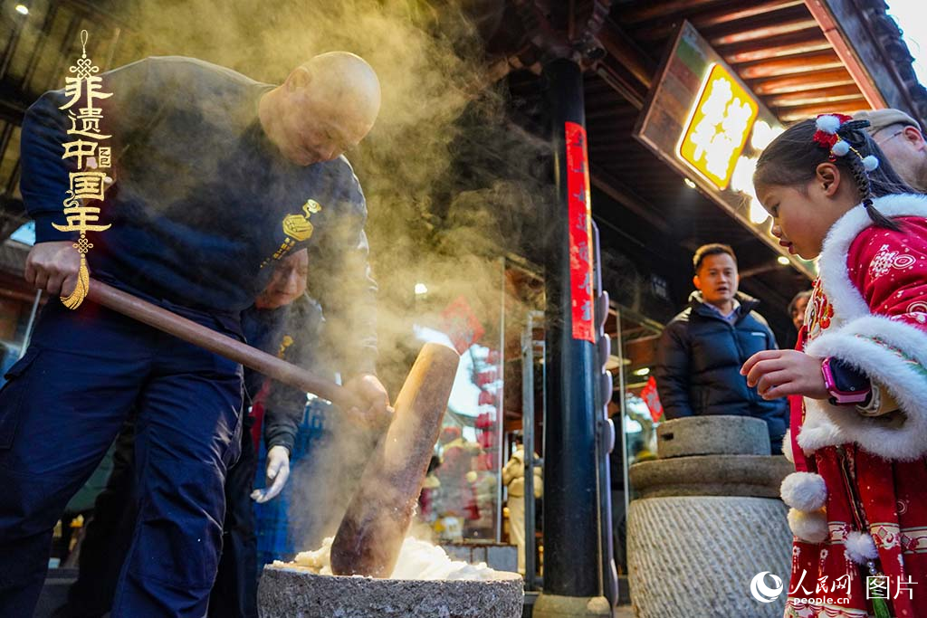 2025年1月29日，浙江省寧波市江北區(qū)慈城古縣城，市民和游客觀看搗年糕。人民網(wǎng) 章勇濤攝